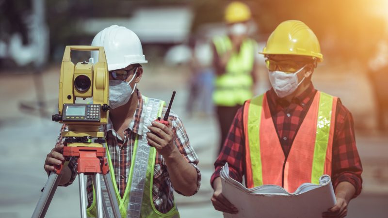 Engineering team surveying on the construction site