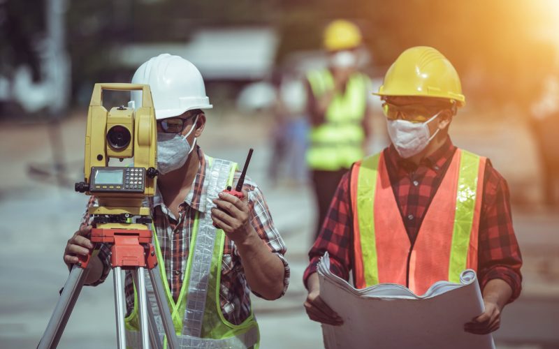 Engineering team surveying on the construction site